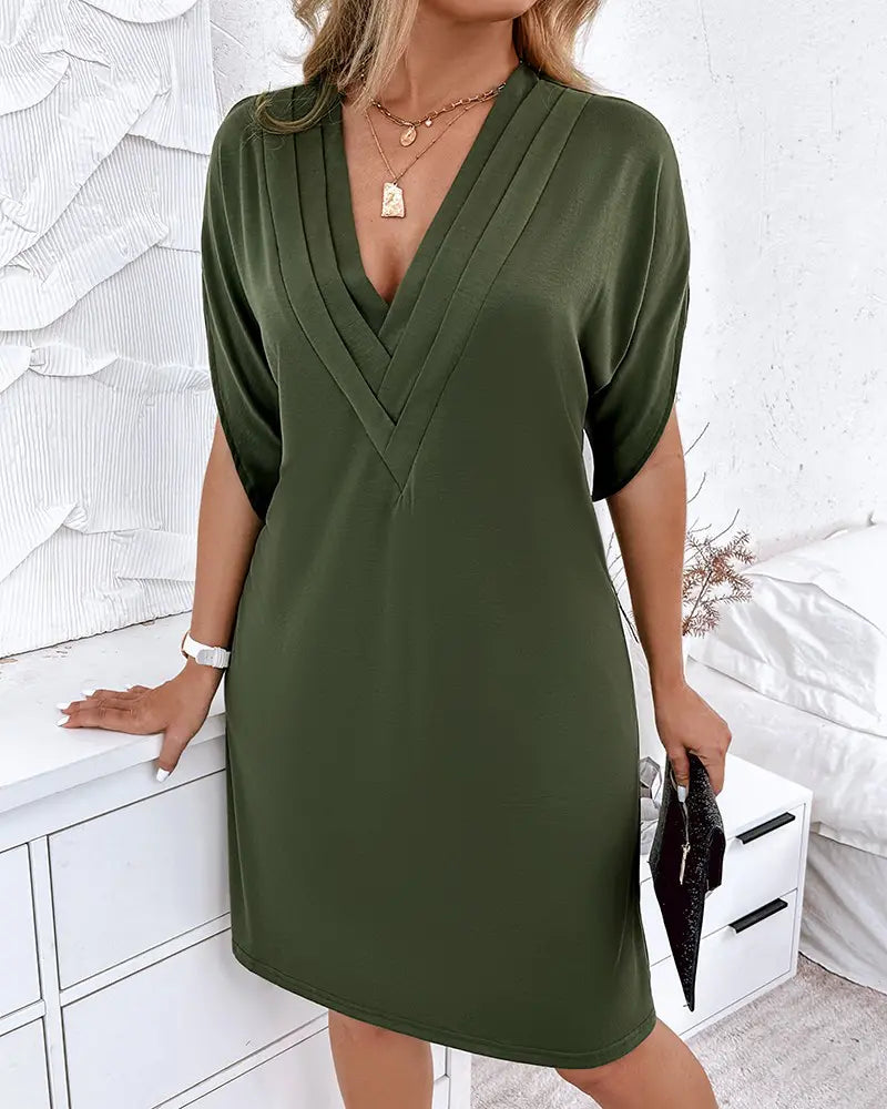 Women's dress with V-neck, short sleeves, and ruffle details