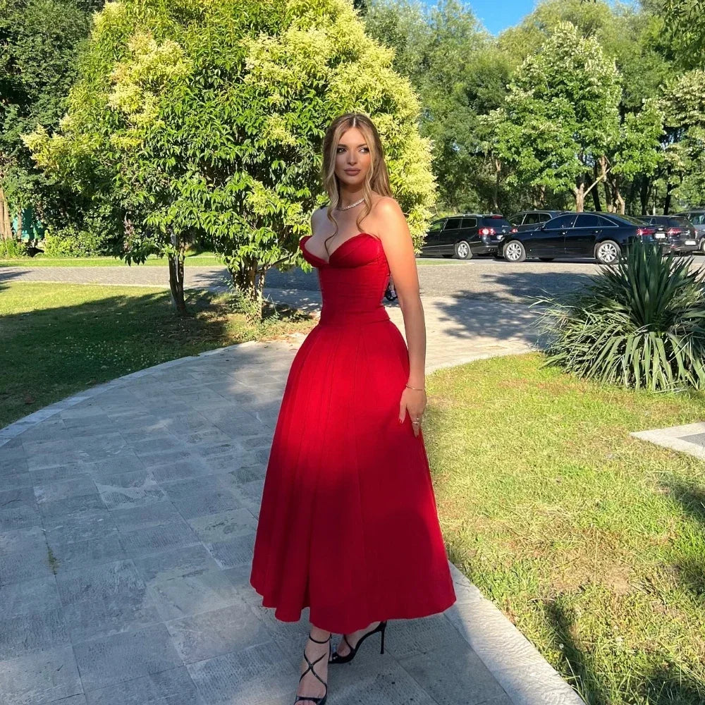 Women's midi dress in red polyester blend fabric with pleats and strapless neckline