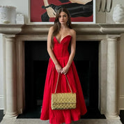 Women's midi dress in red polyester blend fabric with pleats and strapless neckline