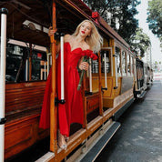 Women's midi dress in red polyester blend fabric with pleats and strapless neckline